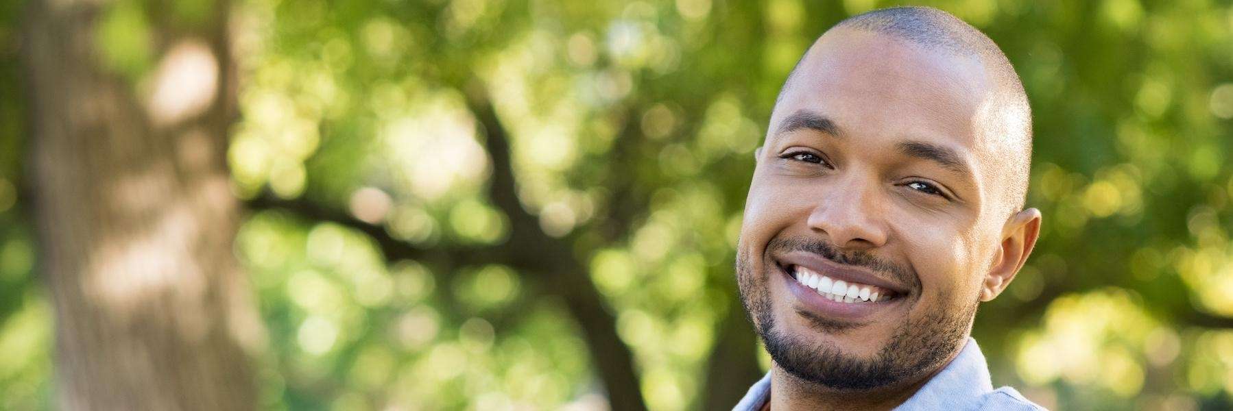 A black man in Mitchell, SD confidently smiles with his white teeth