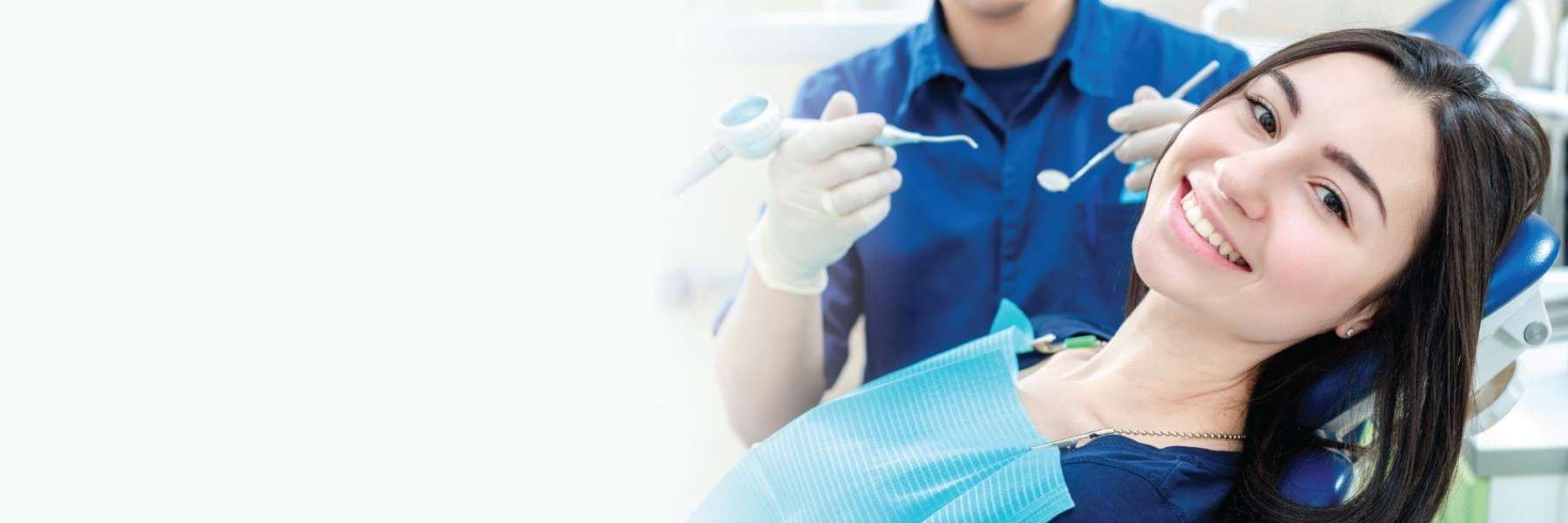 A lady in a Mitchell dentist chair smiling as shows her clean teeth