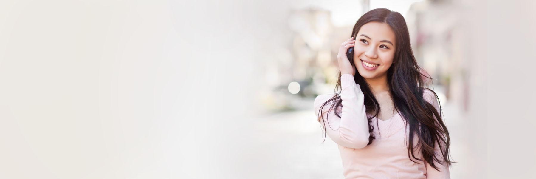 Woman on the phone scheduling a dental exam in 57301